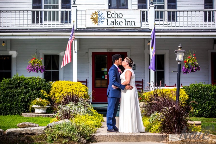 Bride-and-groom-kiss-in-front-off-echo-lake-inn-home-to-vermont-weddings Bride-and-groom-kiss-in-front-off-echo-lake-inn-home-to-vermont-weddings
