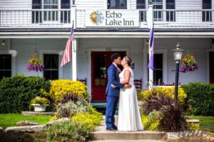 Bride-and-groom-kiss-in-front-off-echo-lake-inn-home-to-vermont-weddings Bride-and-groom-kiss-in-front-off-echo-lake-inn-home-to-vermont-weddings